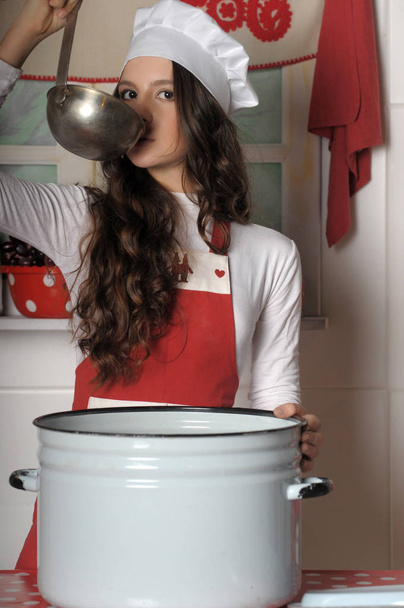 beautiful brunette in a cook hat - Foto, Bild