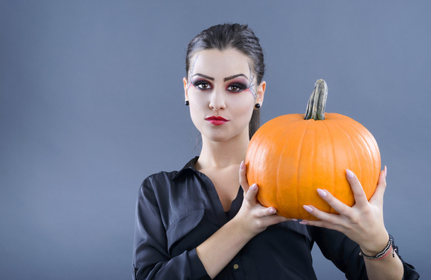 beautiful girl with pumpkin in the studio isolated on gray backg - Zdjęcie, obraz