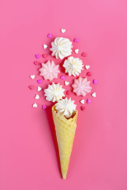 close-up shot of meringues and ice cream cones on pink surface - Fotografie, Obrázek