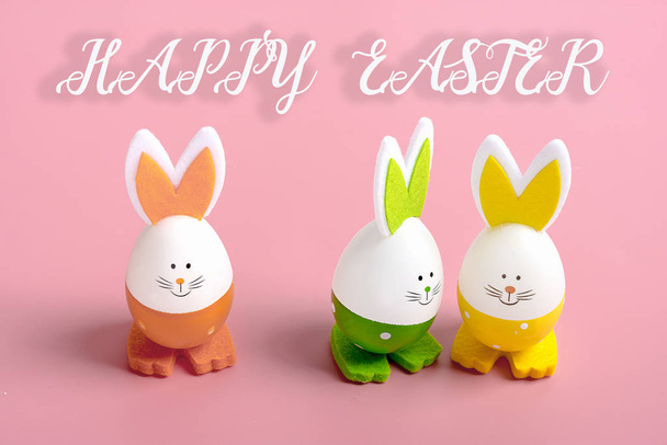 set of easter bunnies in shape of eggs on pink - Foto, afbeelding