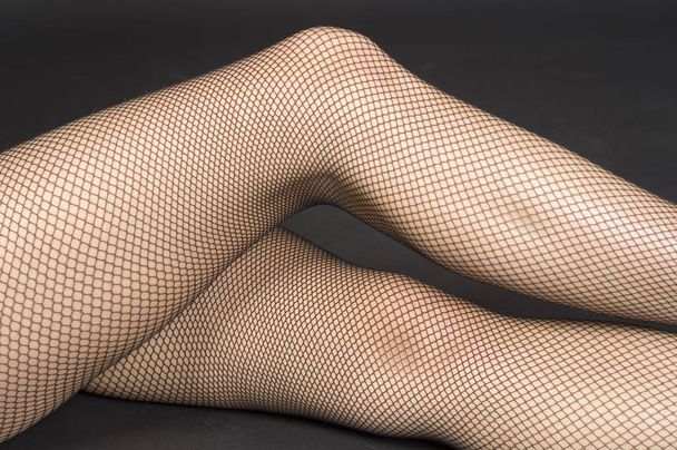 sexy ass of woman in black stockings on the floor - Fotó, kép