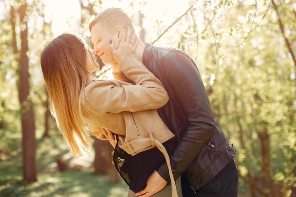 Beautiful couple spend time in a spring park - Фото, изображение