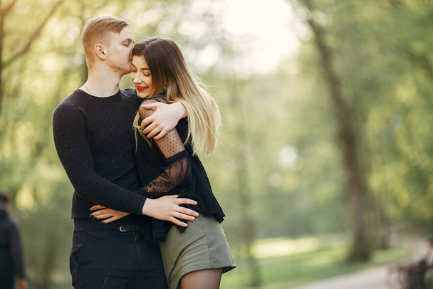 Beautiful couple spend time in a spring park - 写真・画像