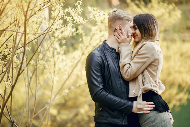 Beautiful couple spend time in a spring park - Фото, зображення