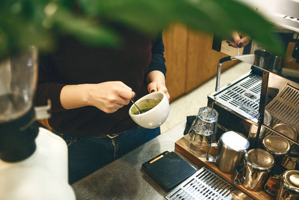 Barista prepares matcha latte tea - Фото, изображение