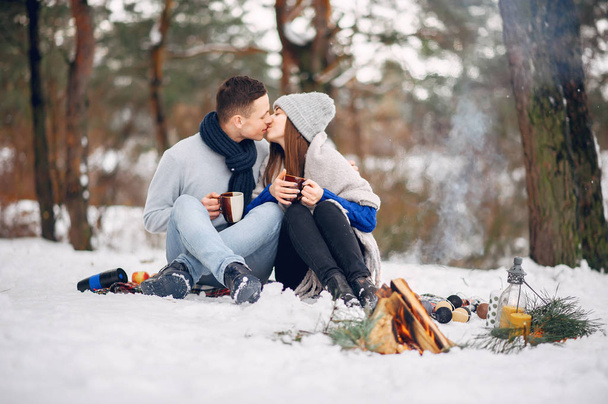 Cute and loving couple in a winter forest - Fotografie, Obrázek