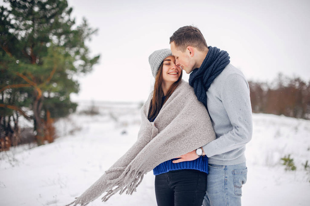 Cute and loving couple in a winter forest - Photo, Image