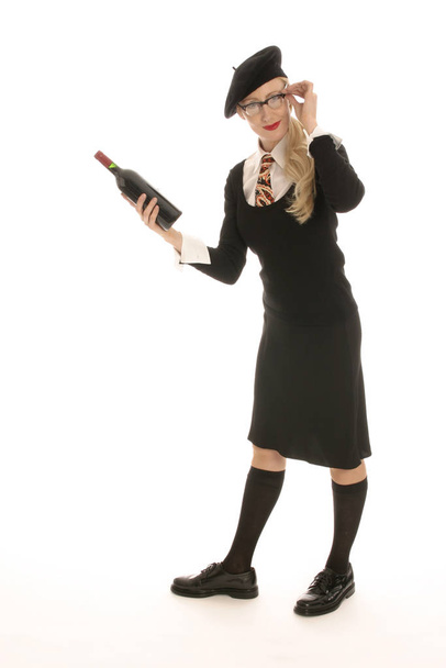 young,blond woman holds wine bottle - Фото, зображення
