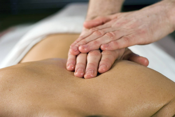 young woman receiving massage treatment in spa - Foto, imagen