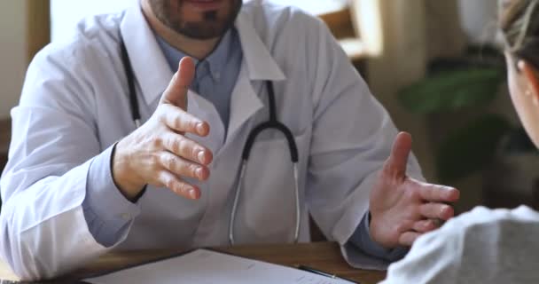 Male doctor consult handshake female patient at medical appointment, closeup - Video