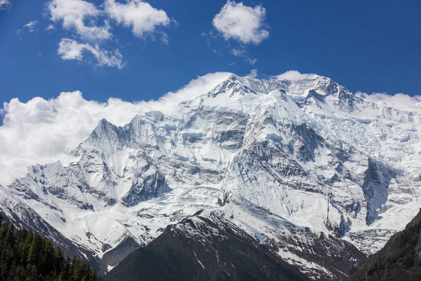 Nepal snowy mountains against the blue sky with clouds - Photo, Image