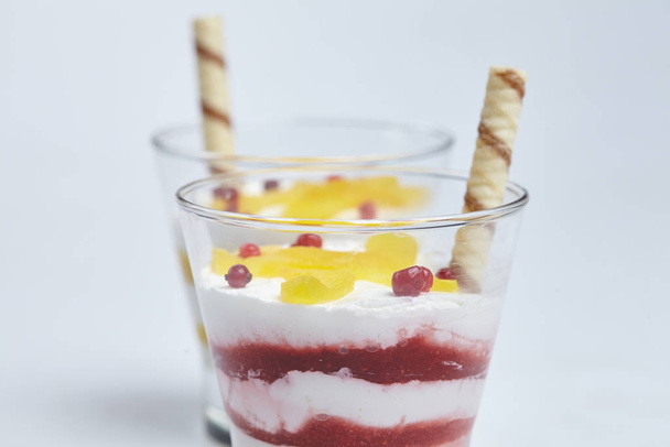 postres con frutas en vasos sobre fondo blanco, primer plano
  - Foto, Imagen