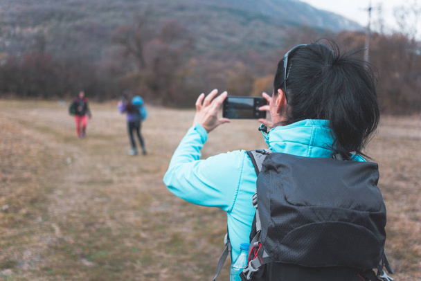 Female hikers taking photos with cell phone. Hiking, outdoors activity - Φωτογραφία, εικόνα