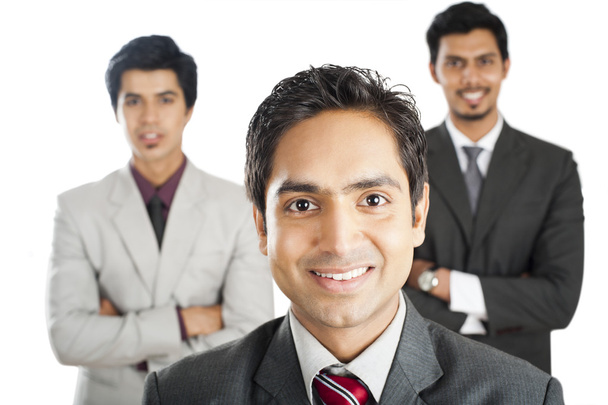 Portrait of a businessman smiling with his colleagues in the background - Foto, Imagen