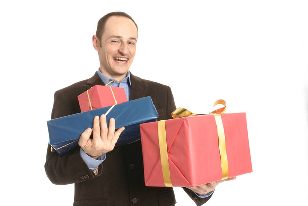 happy businessman holding gift box isolated on white - Fotó, kép