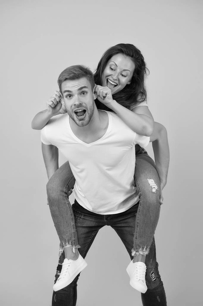Going crazy together. Woman and handsome man crazy mood. Couple crazy in love having fun. Feeling free and crazy. Young people. Family time. Piggybacking girlfriend. Cheerful mood. Positive emotions - Foto, imagen