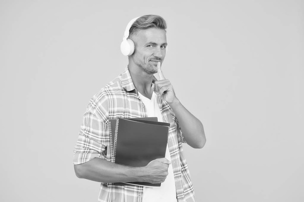 Audio library. Man handsome college student headphones books. Study languages. Another way of study. Learning english. Educational technology. Study. Audio book concept. Worldwide knowledge access - Fotoğraf, Görsel