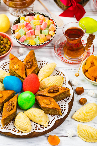Novruz Ramadan in Azerbaijan. Colored Eggs, Wheat Springs for Easter and Traditional Sweets. Selective focus. - Photo, Image