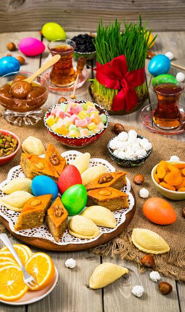 Novruz Ramadan in Azerbaijan. Colored Eggs, Wheat Springs for Easter and Traditional Sweets. Selective focus. - Photo, Image