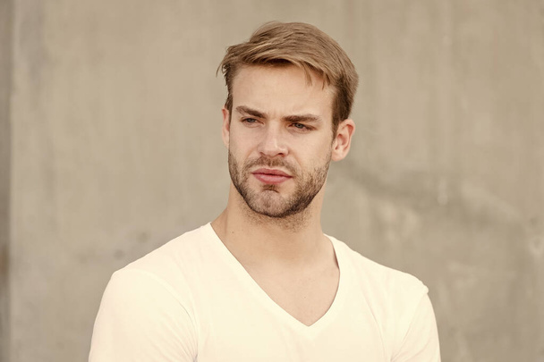 Handsome man unshaven face stylish hairstyle. Handsome caucasian man gray background. Bearded guy casual style close up. Male beauty standards. Ideal traits that make man physically attractive - Photo, Image