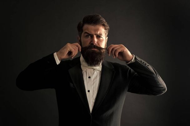 Proud of his moustache. Brutal hipster twirl moustache. Serious guy wear long beard and moustache. Bearded man with stylish moustache hair. Barbershop. Barbers - 写真・画像