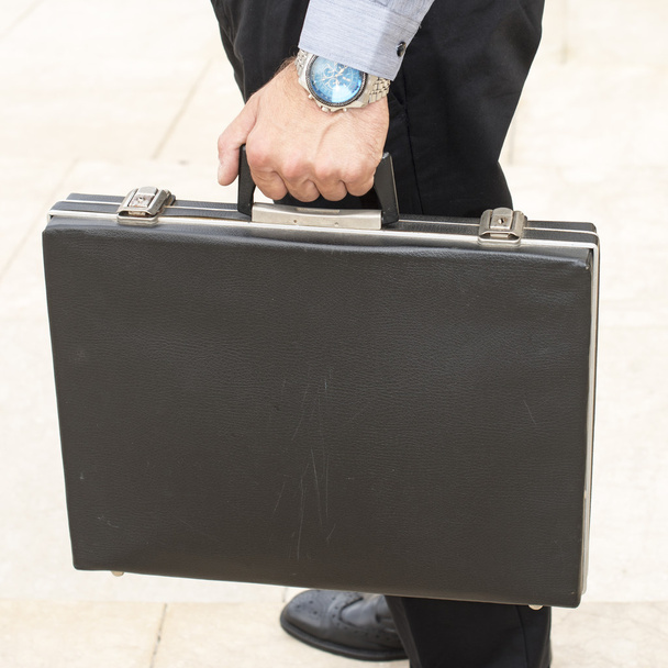 Hand holding old briefcase. - Foto, Imagem