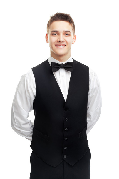 young smiling waiter isolated on white background - 写真・画像
