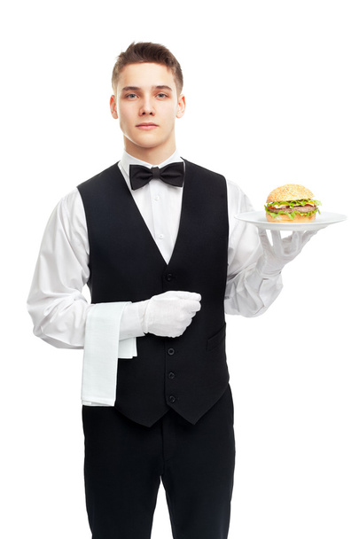 Young waiter holding hamburger on plate - Foto, Imagen