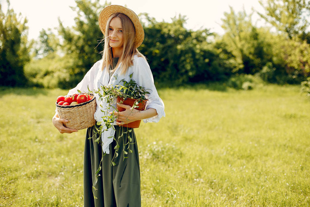 Beautiful woman in a summer field - Фото, изображение