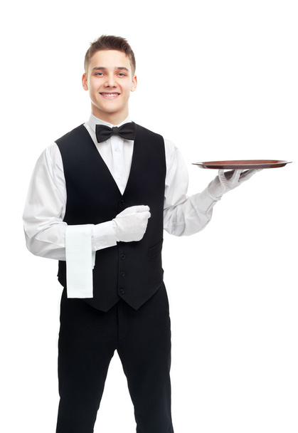 Young smiling waiter with empty tray - Foto, afbeelding
