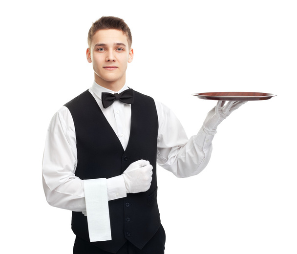 Young smiling waiter with empty tray - 写真・画像