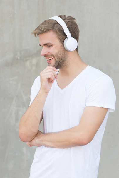 Audio fun. Happy guy listen to audio in headphones. Handsome man enjoy audio learning. Audio course. Listening experience. New technology. Modern life. He is audiophile - Zdjęcie, obraz