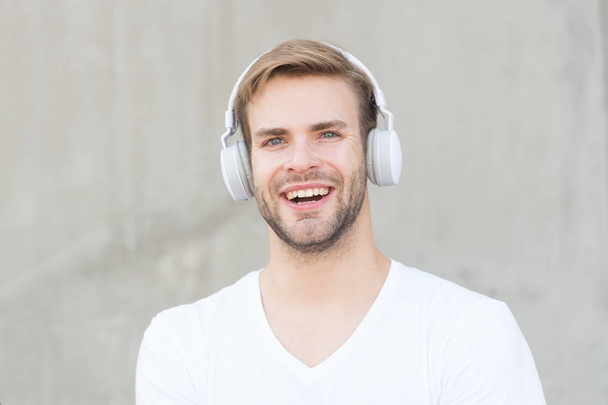 Music makes my day. Happy man listen to music grey background. Handsome guy enjoy music playing in headphones. Modern life. New technology. Fun and entertainment. Music is fun - Photo, image