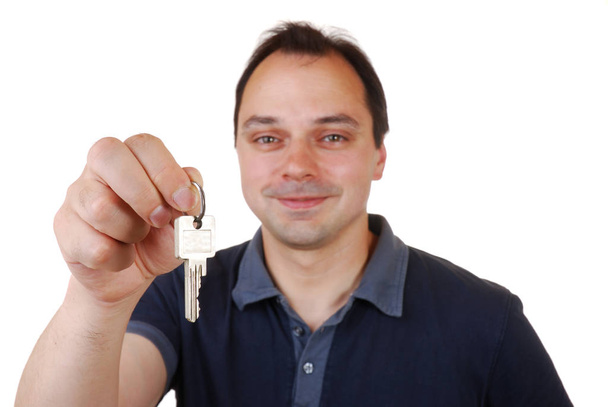 young man holding a key - Fotó, kép