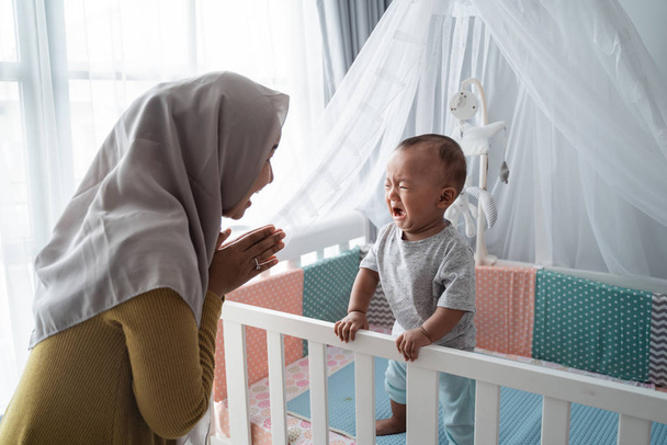mother looking at her baby boy crying - Photo, Image
