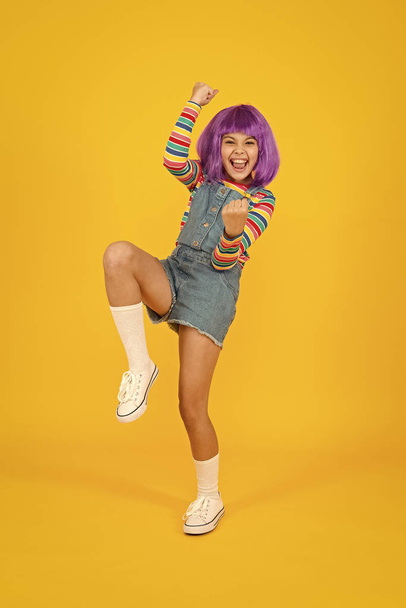 Cosplay character concept. Culture hobby and entertainment. Cosplay outfit. Otaku girl in wig smiling on yellow background. Happy childhood. Anime fan. Cosplay kids party. Child cute cosplayer - Fotó, kép