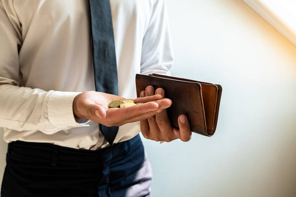 The hands of businessmen holding coins and wallets to save money, expand a growing business to success and save for retirement concepts - Foto, Imagem