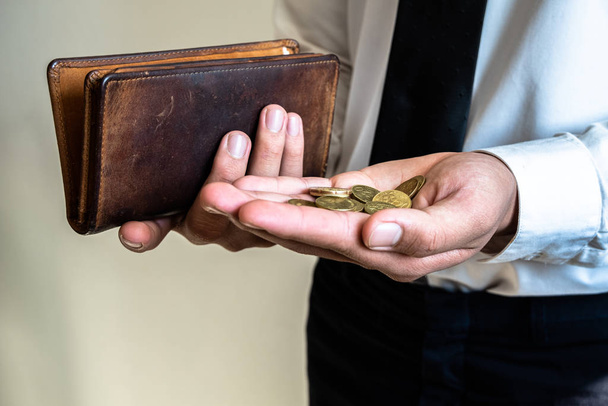 The hands of businessmen holding coins and wallets to save money, expand a growing business to success and save for retirement concepts - Foto, imagen