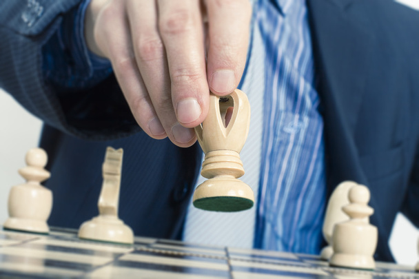 Business man moving chess figure - Zdjęcie, obraz