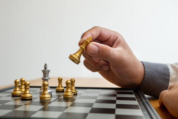 hand of businessman moving chess in competition, shows leadership, followers and business success strategies - Zdjęcie, obraz
