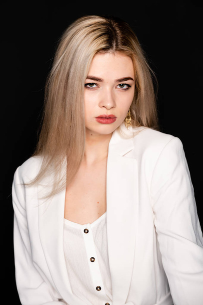 close up portrait of beautiful young model with blonde hair and black clothes, posing in photostudio on dark background - Φωτογραφία, εικόνα