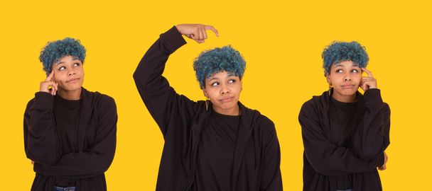 young african american girl or woman with blue hair isolated on yellow background - Foto, Bild