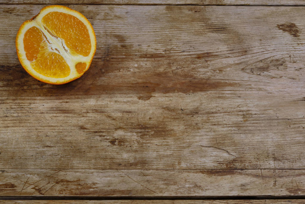 Orange on the weathered wooden surface copy space - Zdjęcie, obraz
