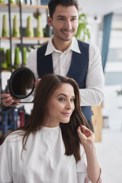 Hairdresser and female customer in hair salon  - Zdjęcie, obraz