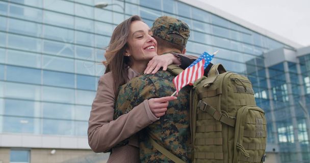 Girl running and cudling military man. - Photo, Image