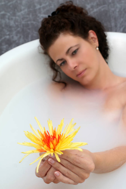 young woman in a bath with flowers - Photo, image