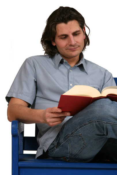 a young man reading a book - Foto, imagen