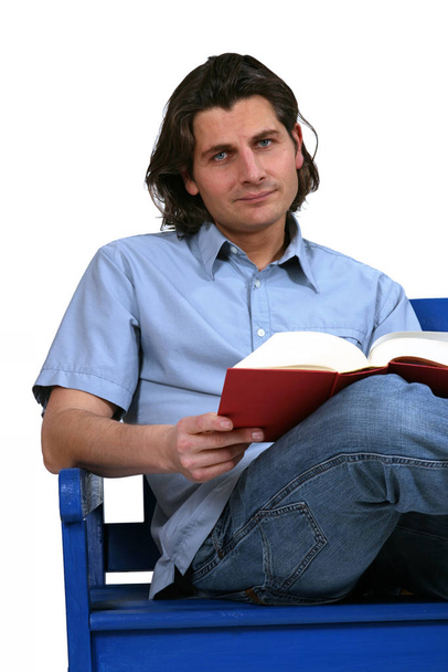 a young man reading a book - Photo, image