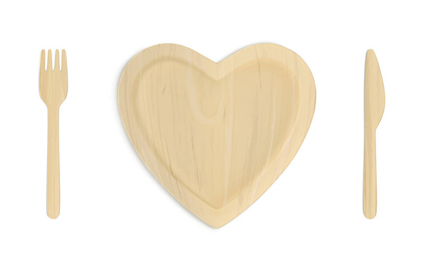 Wooden heart plate with fork and knife top view - Vector, Image
