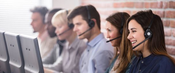 Female Customer Services Agent Working In A Call Center - Photo, Image